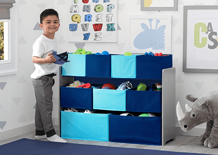 Child organizing toys using animal-themed storage bins and bookcases for kids in a colorful playroom.