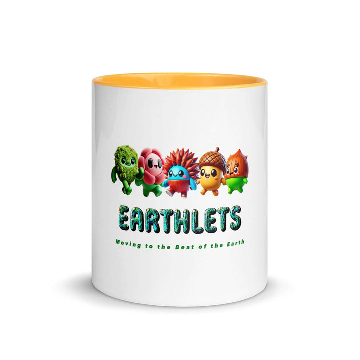 White ceramic mug with colorful interior featuring cartoon Earthlets characters and text 'Moving to the Beat of the Earth'.