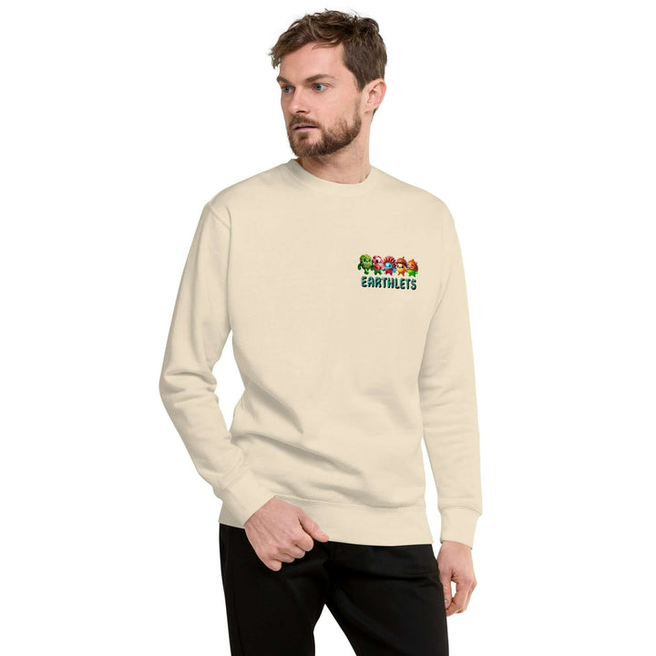 Man wearing an Earthlets unisex premium sweatshirt in beige, featuring a colorful logo on the front.